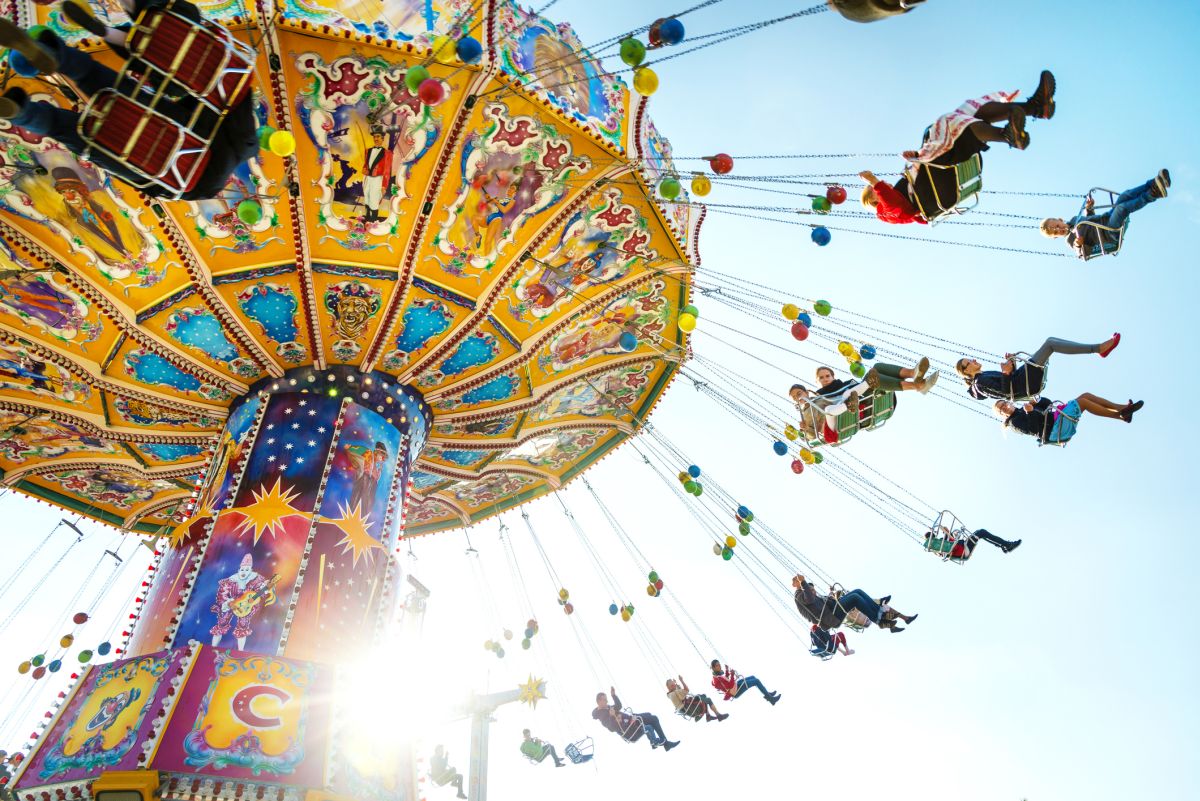 Munich, Germany - October 01, 2013: People enjoy the ride on a carousel during a sunny afternoon at the Oktoberfest in Munich (Germany). The Oktoberfest is the biggest beer festival of the world with over 6 million visitors each year. Bild: © istock.com / Nikada